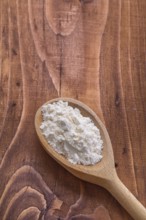 Wooden spoon on vintage wooden board with copyspace concept