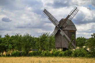 A view of a beautiful windmill in Thuringia Germany in a natural setting and an eye catcher for