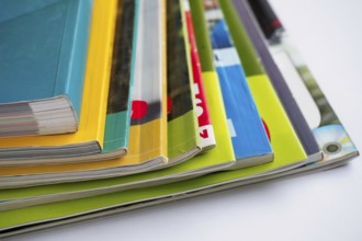 Stack of magazines on white background