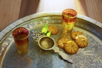 Green tea with mint Moroccan style on silver tray and biscuits