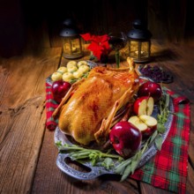 Festive stuffed roast goose with red cabbage and dumplings