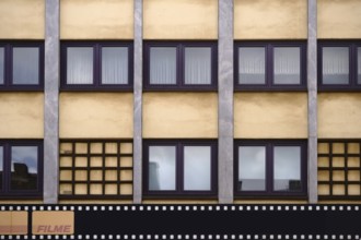 The exterior facade of a photo shop with a painted film strip