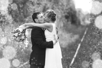 Bride and Groom embracing with happy smile on their faces