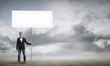Fullbody of handsome guy holding white blank banner