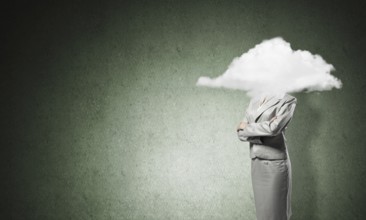 Businesswoman with arms crossed on chest and head in cloud