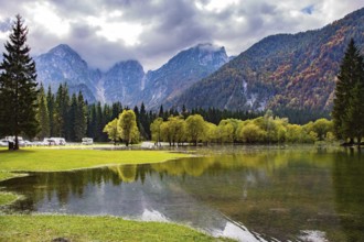 Picturesque lake Fusine in Northern Italy. The smooth surface of the water reflects the surrounding
