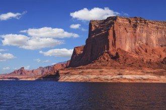 Lake Powell is surrounded by magnificent red hills. Scenic huge artificial water basin of the