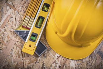 Square ruler construction level hard hat wooden meter on OSB