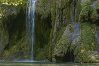 The tufa waterfall near Arbois. Crystal clear waterfall, powerful waterfall