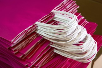 Paper bags atacked in a factory pink color bag