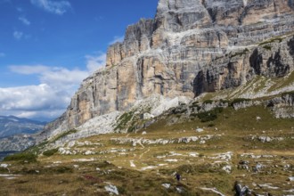 Male mountain climber on a Via Ferrata in breathtaking landscape of Dolomites Mountains in Italy.