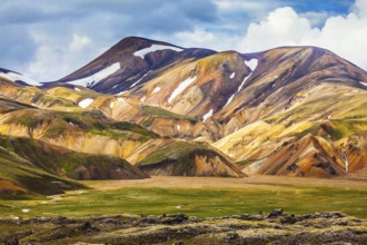 National Park Landmannalaugar. On the gentle slopes of the mountains are snow fields and glaciers.
