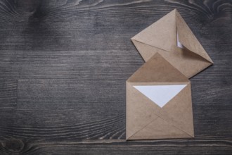 Vintage envelopes on wooden board copy space