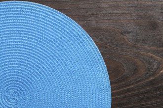 Wickered round mat on vintage wooden board
