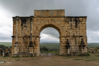 Volubilis, Morocco, 3 March, 2024: view of the ruins of the Triumphal Arch and city gate in the