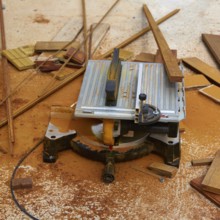 Circular table saw carpenter tool and sawdust in deck installation