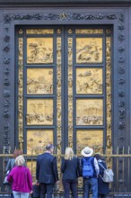 Tourists at the Gates of Paradise at the Baptistery of Saint John in Florence, Italy, Europe
