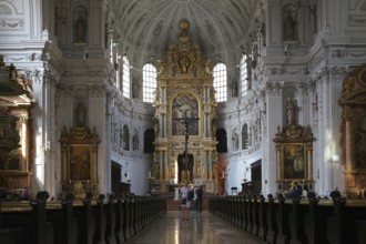 Munich, Germany - June 30, 2018: The altar and the golden and sacredly decorated interior of St.