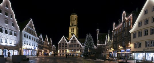 Panoramic night photo of the historic buildings around the market square with Christmas tree and