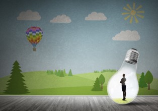 Businesswoman inside light bulb in room against nature drawn concept