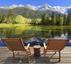 Comfortable lounge chairs on wooden platform for rest and observation. City park in the Alpine