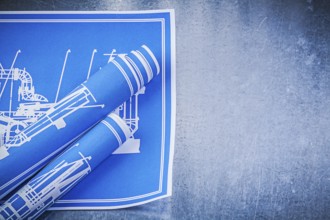 Blue construction plans on metallic background maintenance concept
