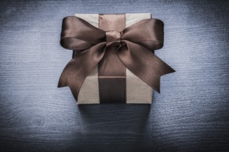 Packed gift box on vintage wooden board holiday concept