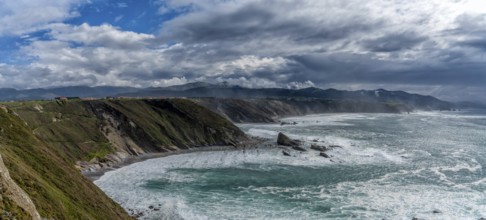 A panorama view of the rugged cliffs and coastline at Cabo Vidio in Asturias under an expressive