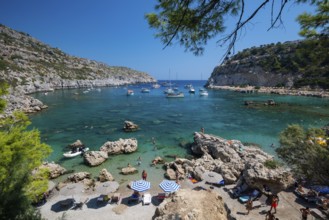 Beach umbrellas and sunbeds, turquoise waters, Anthony Quinn Bay, Faliraki, Rhodes, Dodecanese,