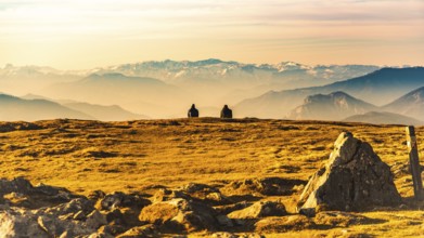 Two people enjoying view of rocky Austrian mountains from Schockl in Styria Graz. Place for tourism