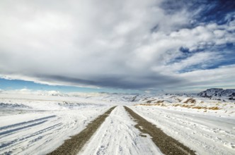 Winter snow-covered road in the Caucasus mountains a wide angle