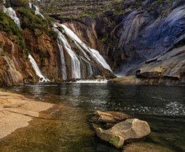 A beautiful waterfall in Ezaro cascading directly into the ocean