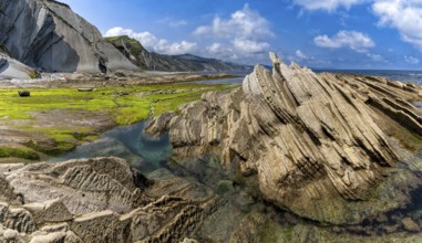 A view of the Flysch rock formations and cliffs with tidal pools on the Basque Country coast near