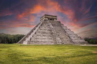 Beautiful clouds at sunrise over the famous Maya pyramid in Yucatan, Mexico that attracts millions