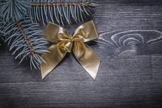 Christmas bow pine tree branch on wooden board holiday concept