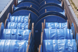 Inland waterway vessel with cargo of blue cable barrels, Hoya, Lower Saxony, Germany, Europe