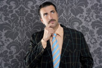 Mustache retro salesman with vintage suit and pensive gesture in wallpaper