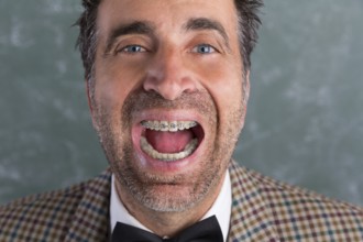 Nerd silly retro man with braces funny expression open mouth