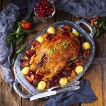 Roast duck with potato dumplings and plums