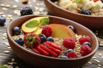 Fruit healthy muesli with peaches strawberry almonds and blackberry in clay dish on wooden kitchen