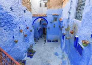Traditional old blue street with color pots inside Medina of Chefchaouen, Morocco, Africa