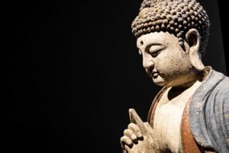 Buddha Statue, Concept of Zen, Spirituality, Peace. Copy space on Black Background, texture light