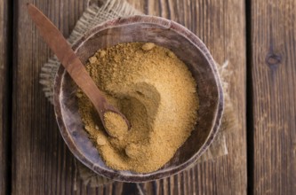 Portion of Coco Sugar (selective focus) on a vintage wooden table