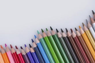 Color Pencils of Various colors placed on white background