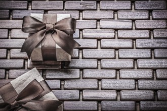Presents packed with tied ribbons on wooden mat holidays concept