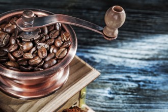Coffee mill seeds on wooden board