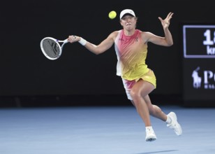 Polish tennis player Iga Swiatek playing a forehand shot at the Australian Open 2025 tournament,