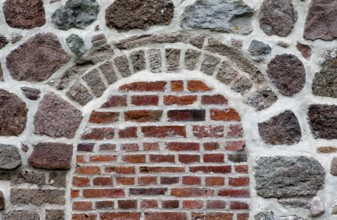 Old stone wall made of erratics rocks and bricks, Church of St. Urbanus, Dorum, Lower Saxony,