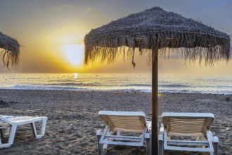 Sunbed and umbrella on the sunset background, Torremolinos, Spain, Europe