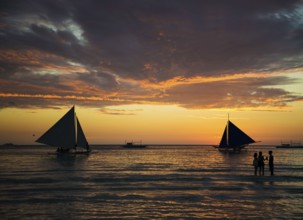 Sailing boats at sunset on boracay island beach philippines